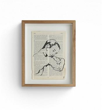Framed ink drawing of a male face on sheet of dictionary paper