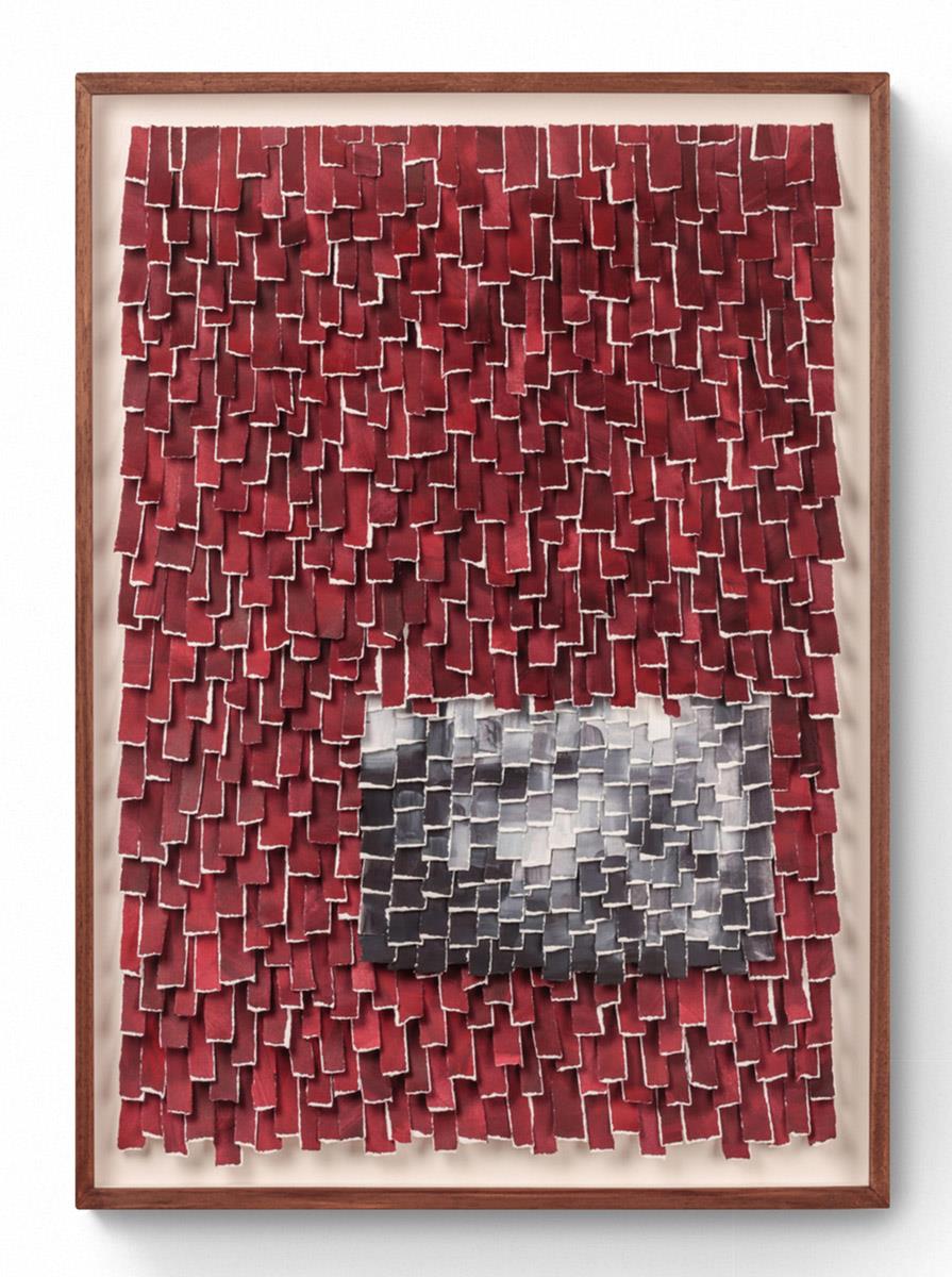 artwork made of hand-torn paper in shades of red in wood frame