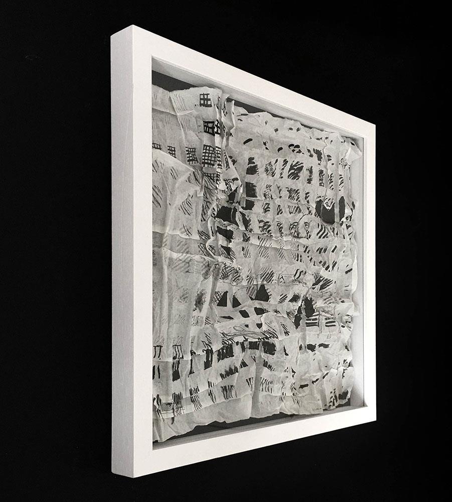 folded paper artwork in white frame