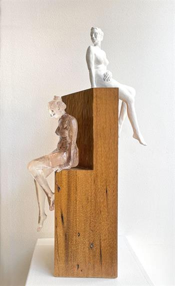 sculpture of two seated nude women