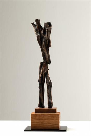 mixed wood sculpture on wood plinth