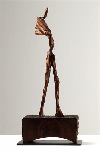 modern wood sculpture on plinth
