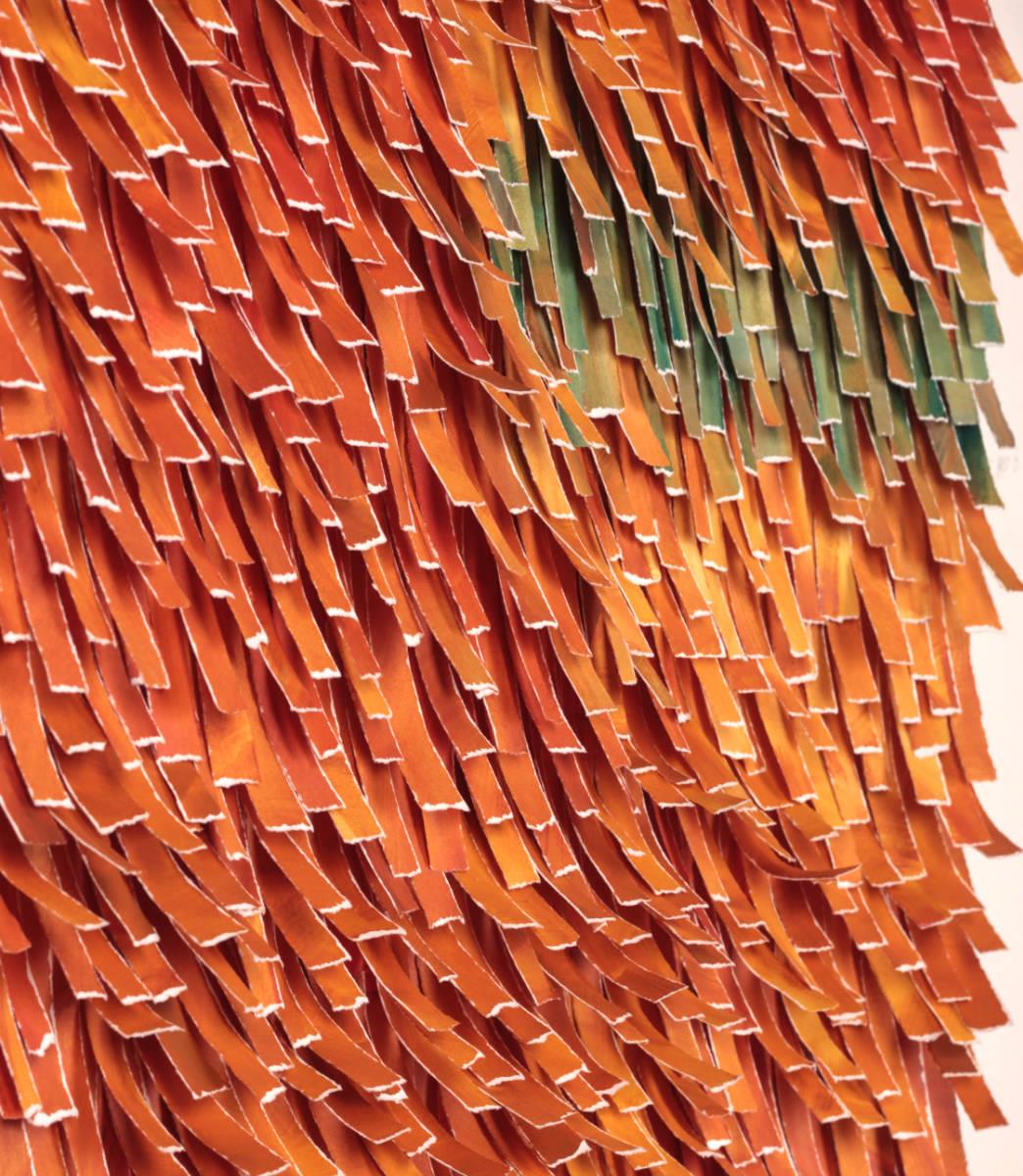 bright orange artwork with a little bit of green made from torn strips of paper