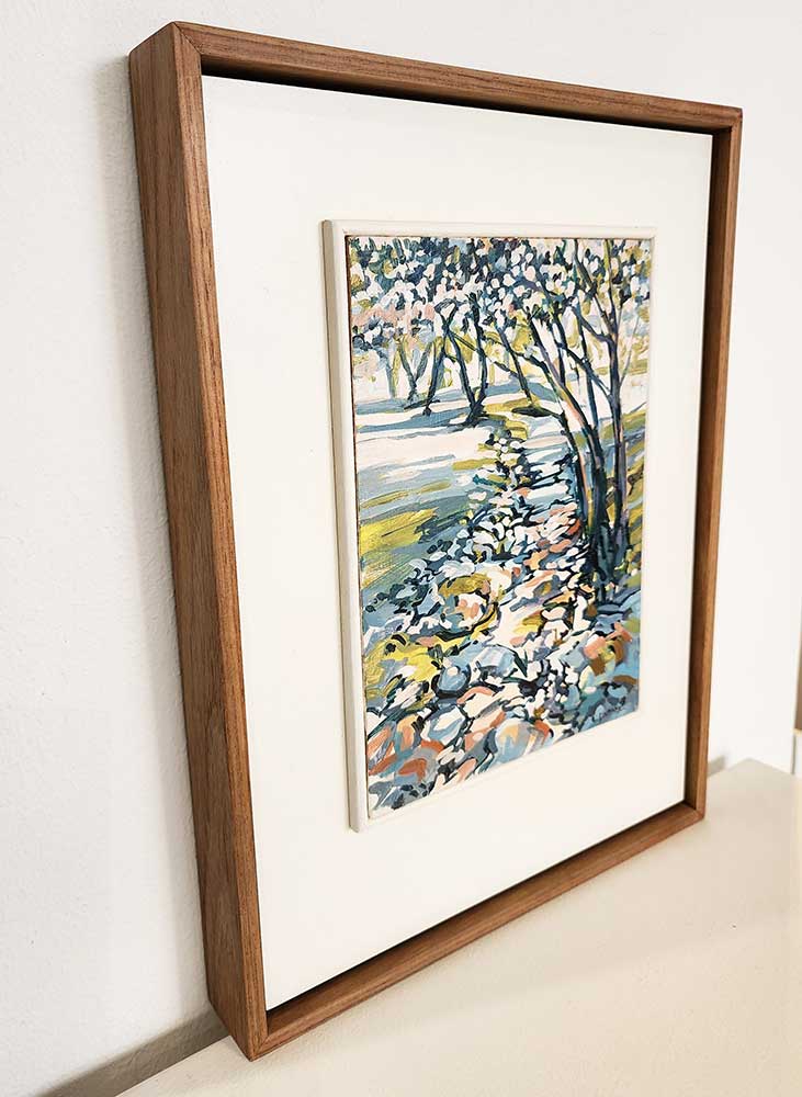 small framed painting of trees in a forest landscape