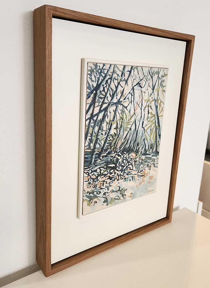 small framed painting of a tranquil woodland scene