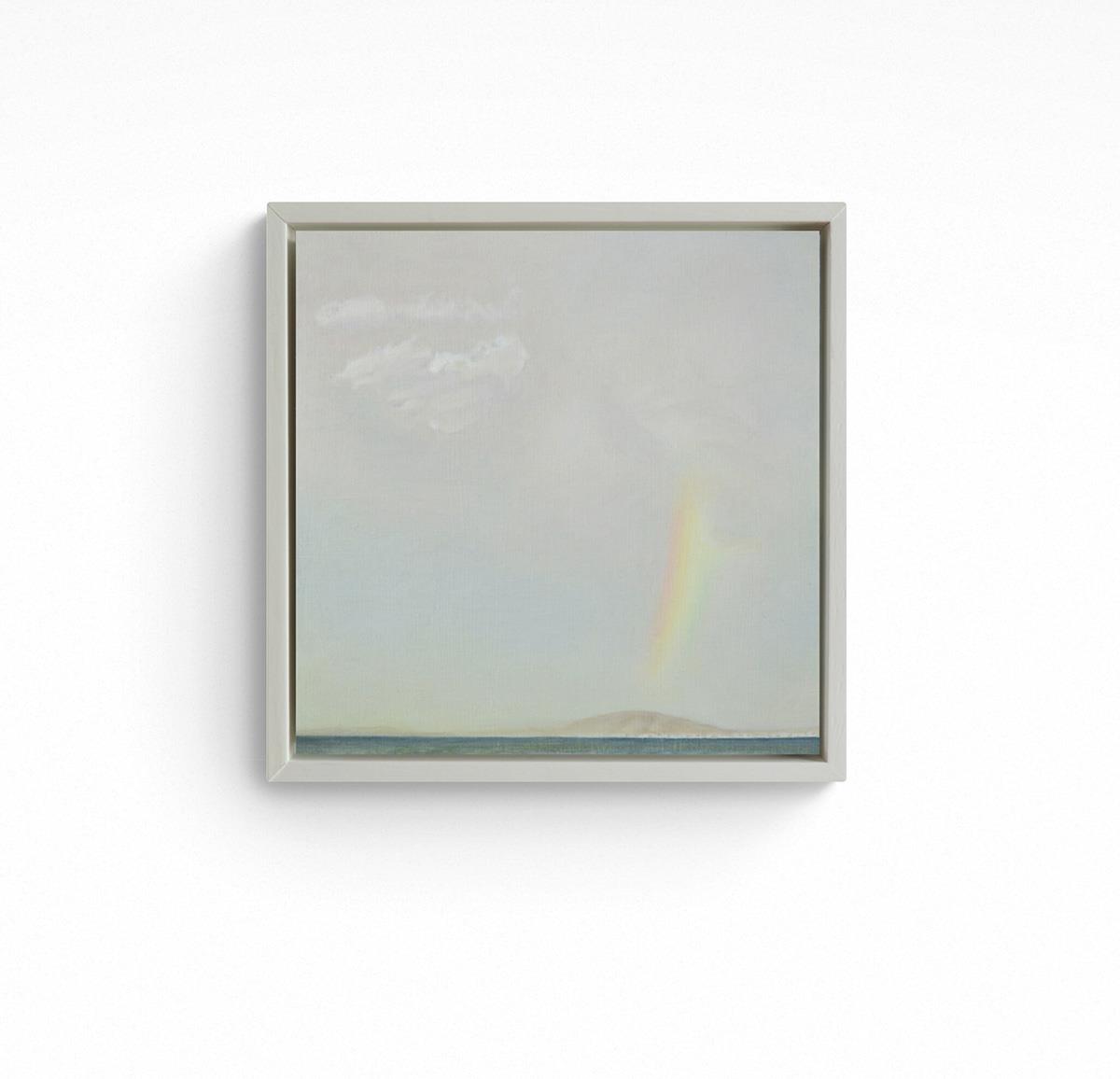 small framed painting of a rainbow in the sky