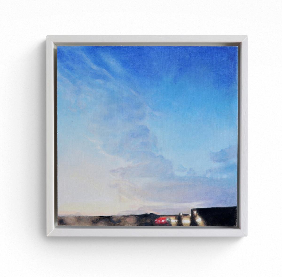 two small framed paintings of the sky at dusk and at dawn