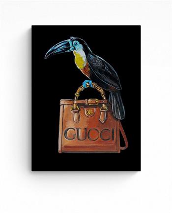 small painting of a toucan bird perched on a Gucci handbag