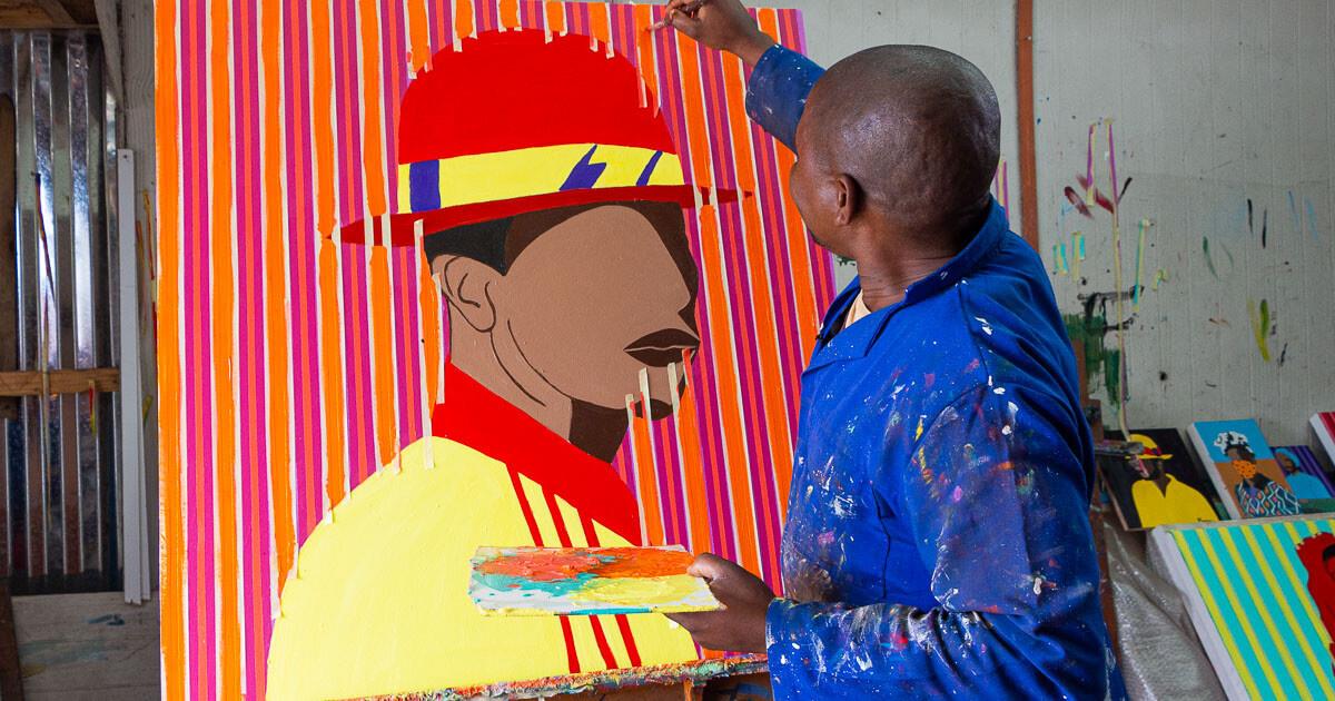 Shakes Tembani painting a portrait of a man wearing a hat in bright colours.