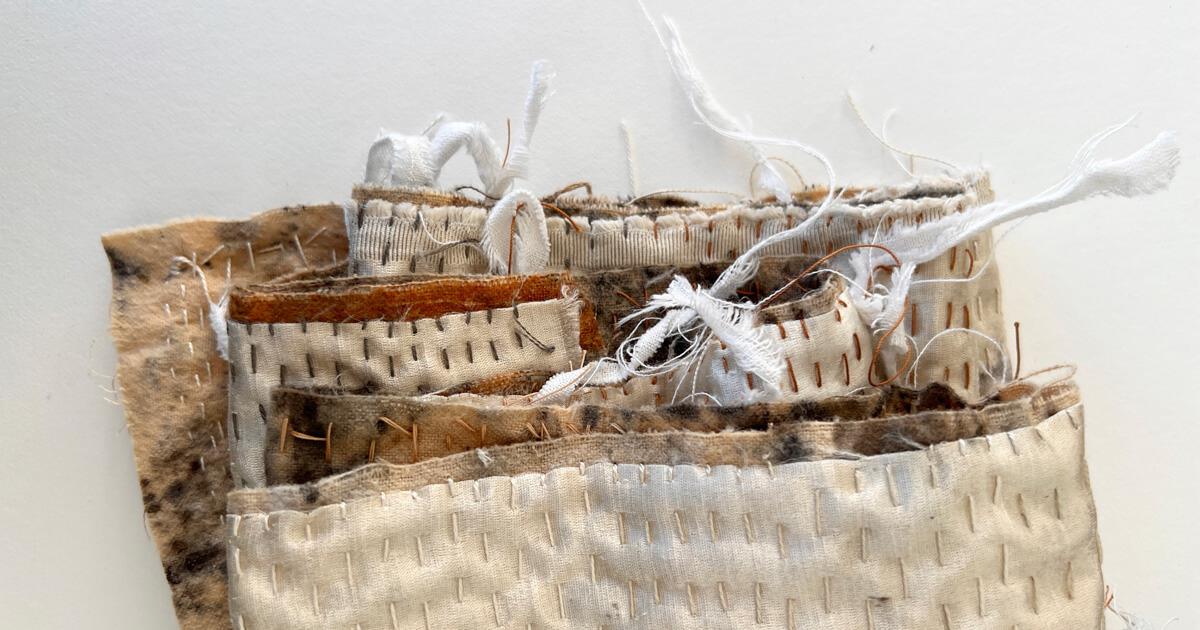 Artwork by Kristen McClarty made of fabric and stitches in shades of brown and white.