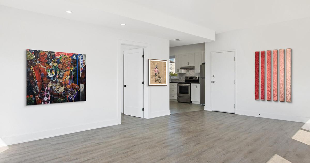 Art by Kufa Makwavarara, Lisette Forsyth and Karla Nixon displayed in a home with white walls.