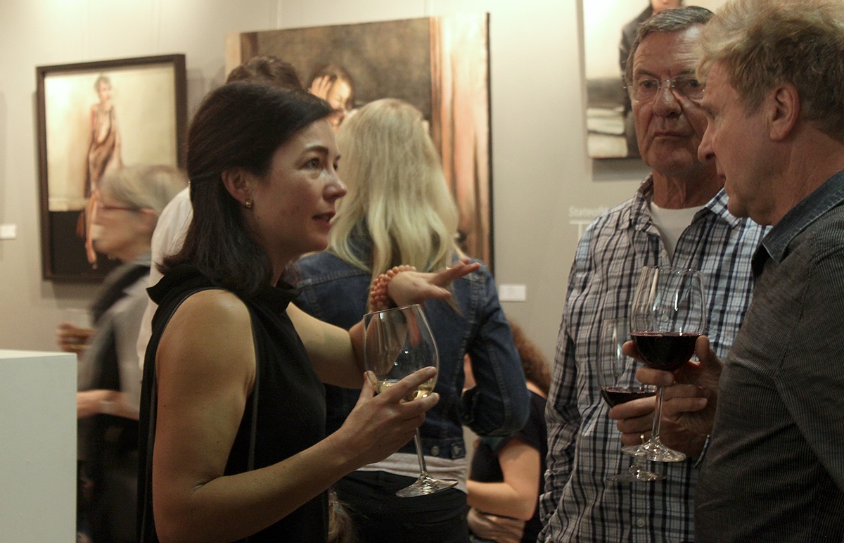 Artist Mila Posthumus speaks to guests at StateoftheART gallery in Cape Town